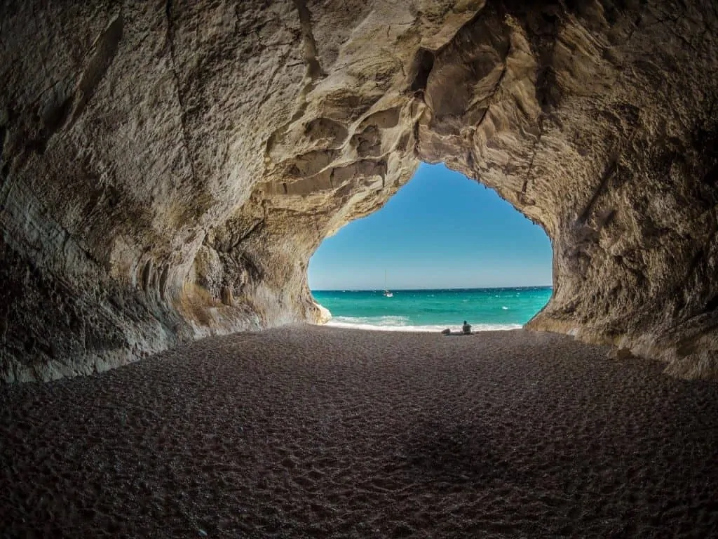 photo of long cave with opening at the end through which you can see the sea and sky: OTHER PROTOCOLS