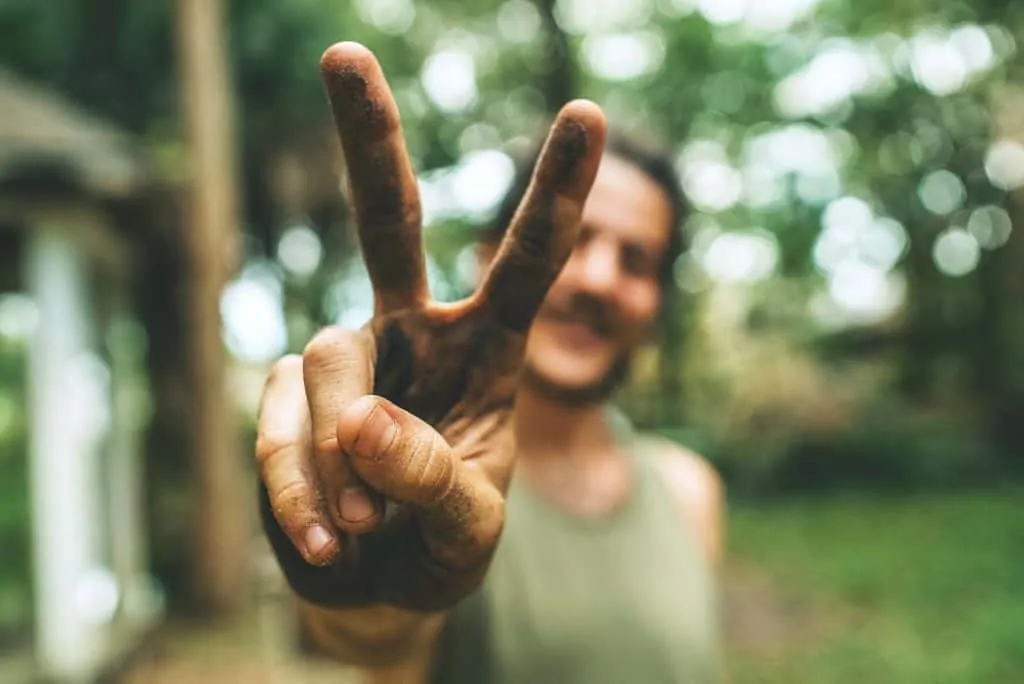 photo of man making peace sign to the camera.