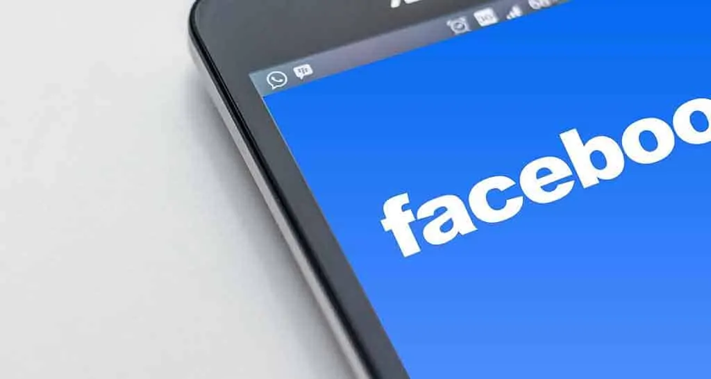 Photo of a tablet with face book on the screen