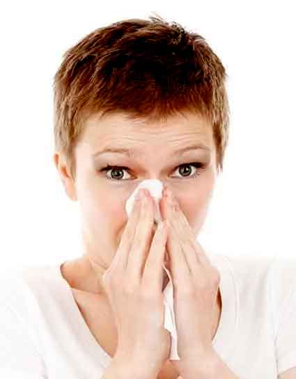 photo of a woman blowing her nose into a tissue; keto diet for beginners