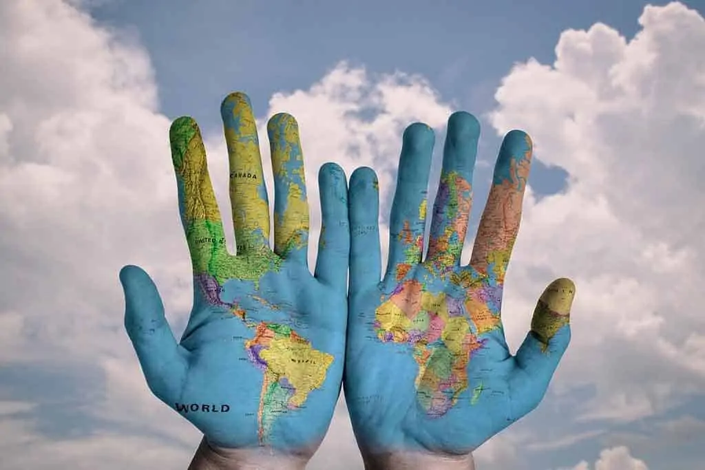 photo of hands against a sky with world map painted onto them. HSCT stops MS.